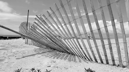 Low angle view of fence against sky