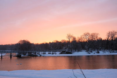 Scenic view of lake against romantic sky at sunset