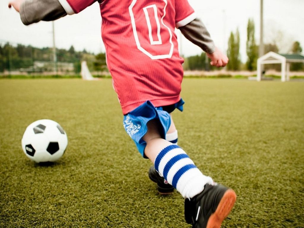 lifestyles, leisure activity, childhood, focus on foreground, grass, field, low section, casual clothing, sport, playing, girls, park - man made space, standing, boys, day, grassy, outdoors, holding