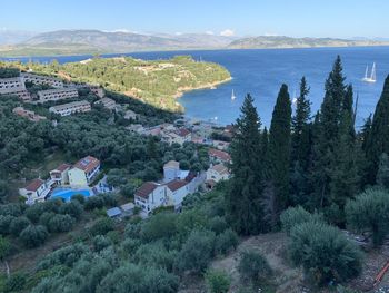 High angle view of townscape by sea against sky