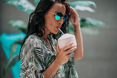 Midsection of a woman drinking water