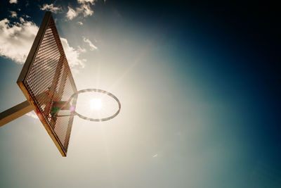 Low angle view of bright sun against sky