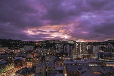 High angle view of illuminated cityscape against romantic sky