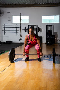 Full length of woman exercising in gym