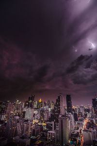 Aerial view of city lit up at night