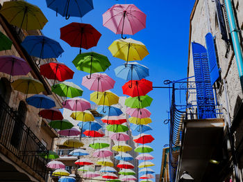 Low angle view of multi colored buildings against blue sky