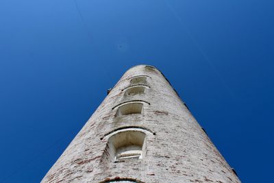 Low angle view of old building against blue sky