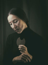 Portrait of young man looking away against wall
