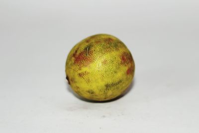 Close-up of fruit over white background
