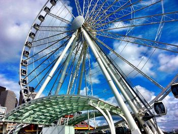 Low angle view of ferris wheel against blue sky