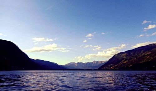 Scenic view of sea and mountains against sky