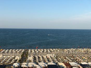 High angle view of crowd by sea against sky