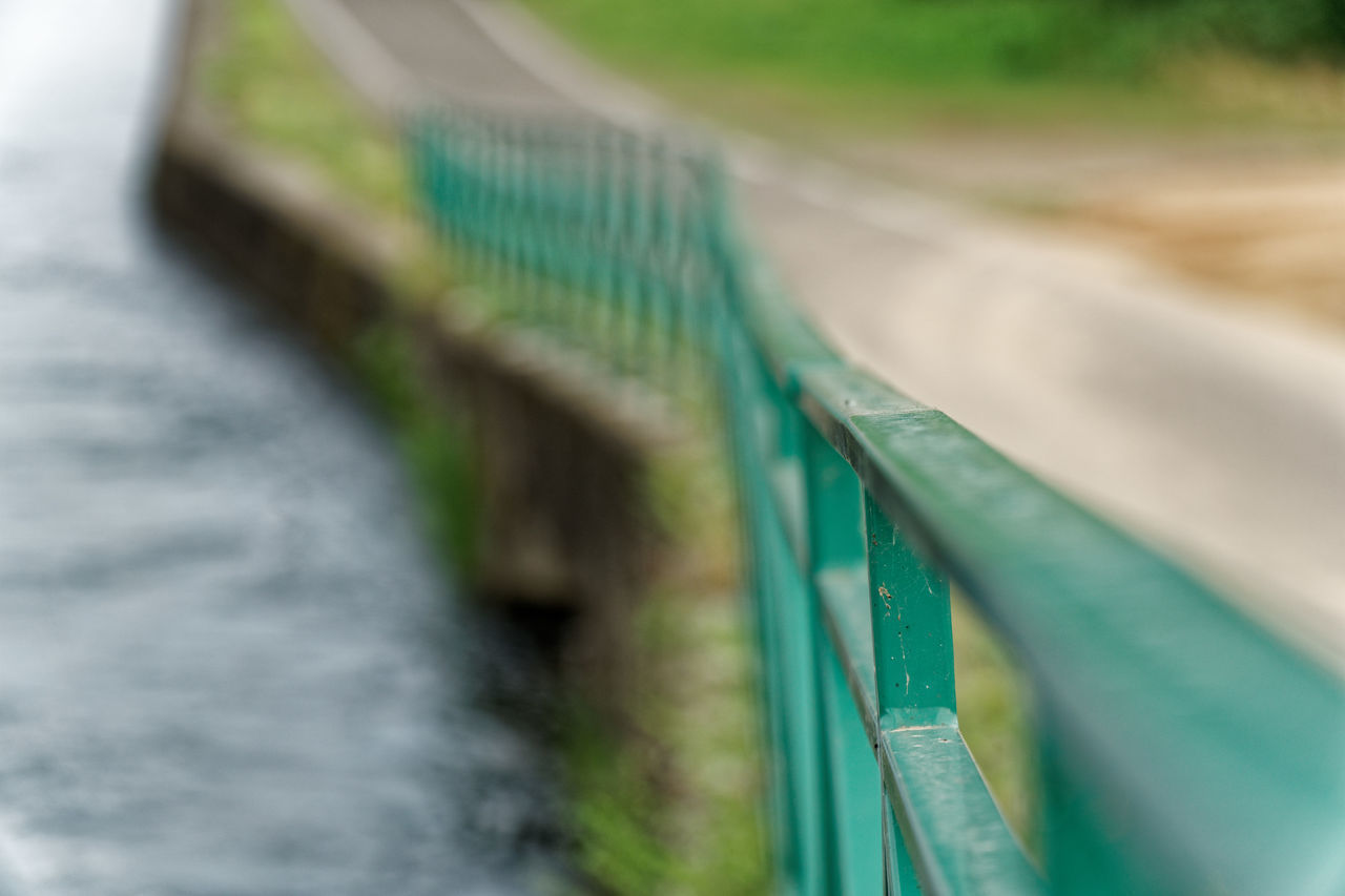 CLOSE-UP OF BRIDGE AGAINST GRASS