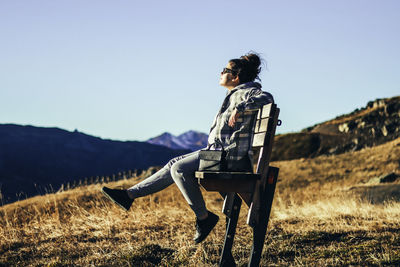 Side view of senior man on field against sky