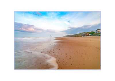 View of beach against cloudy sky