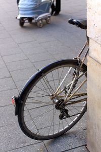 High angle view of bicycle parked on street by wall