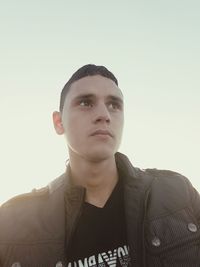 Portrait of young man against white background
