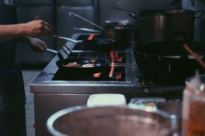 Cropped hand preparing food in kitchen