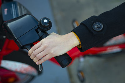 Aerial shot of a hand taking the handlebars of a bicycle.