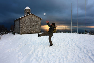 Full length of man standing on snow covered field