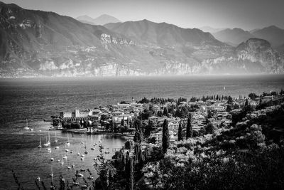 Scenic view of sea and mountains against sky