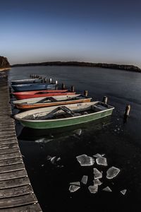 Boats moored on sea against sky