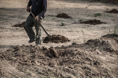 Low section of man working on field