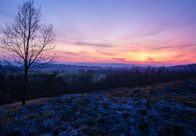 Scenic view of snow covered landscape at sunset