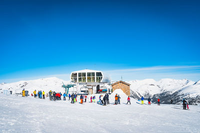 Skiers and snowboarders taking off from ski lift and having fun in winter, andorra