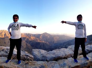 Full length of man standing on mountain against sky