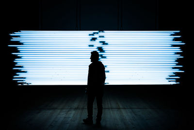 Silhouette of man standing in office