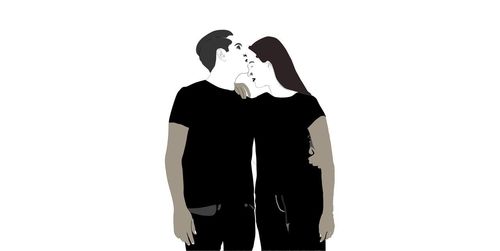 Rear view of couple standing against white background