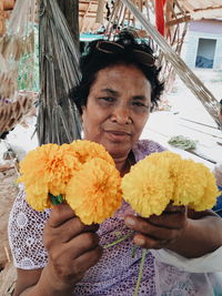 Portrait of woman holding bouquet of flower