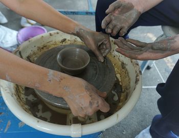 People making mud pots in workshop