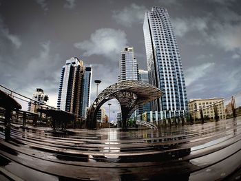 Skyscrapers against cloudy sky