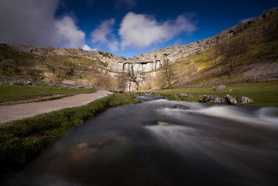 Scenic view of waterfall against sky