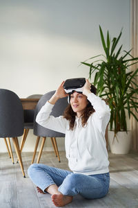 Woman wearing hat sitting on chair