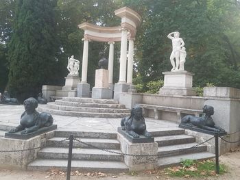 Statue against fountain
