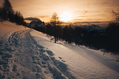 Dramatic colors dolomite winter panorama at sunset with sunlit clouds