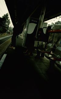 Low section of man walking on road at night