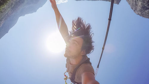 Low angle view of woman against sky