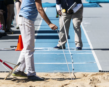 Low section of people walking on road