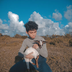 Young man with dog in the field