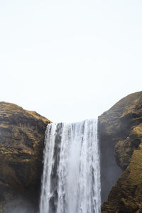 Scenic view of waterfall against clear sky