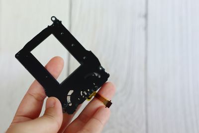 Cropped hand holding camera