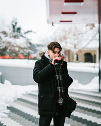 Full length of senior man standing in snow