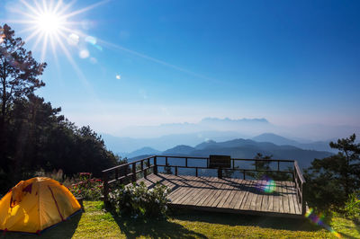 Scenic view of mountains against blue sky on sunny day