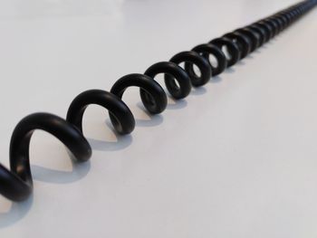 Close-up of phone cord against white background