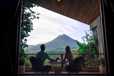 People looking at view through window