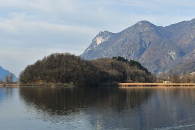 Scenic view of lake and mountains against sky